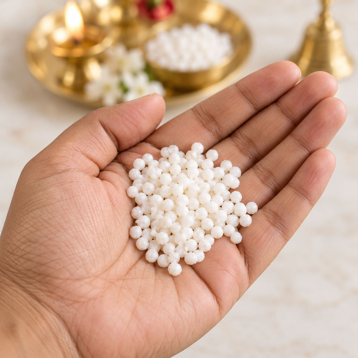 Prasad Dana Elaichi Dana sweet pearls shown naturally in hand